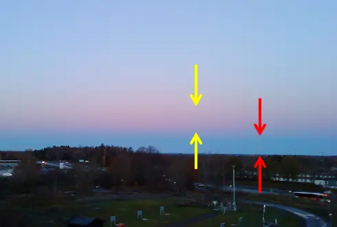 Jordskugga som syns som ett mörkt band i väster vid soluppgången